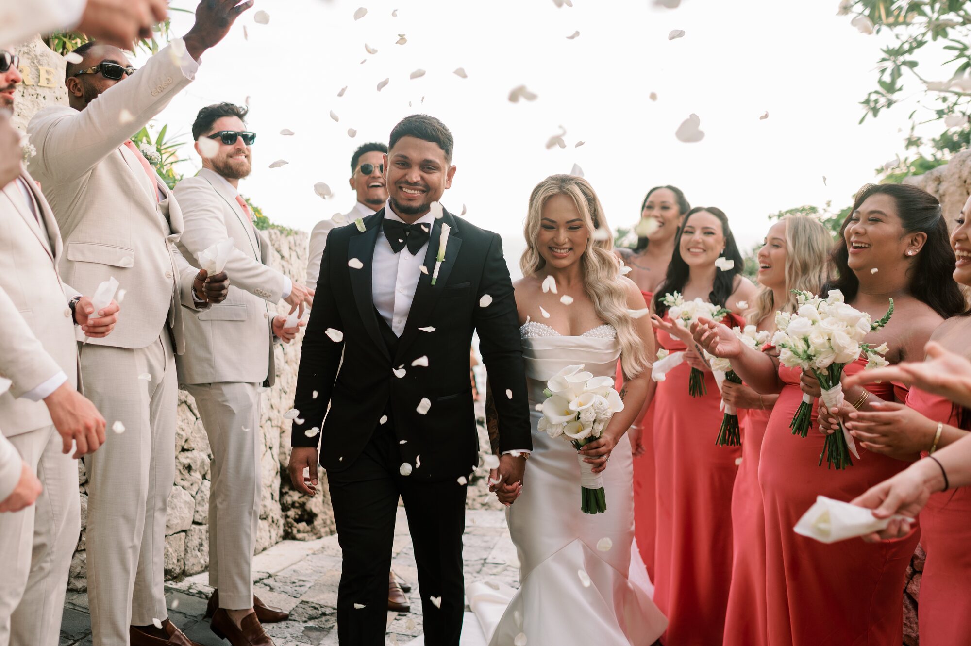 Symbolic sunset wedding ceremony with floral arch on a Bali clifftop
